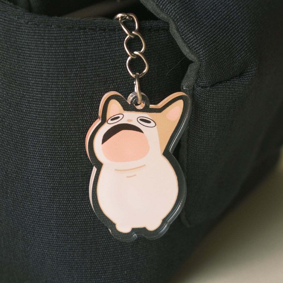 pop cat meme keychain on black bag
